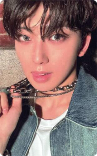 A photocard of Fuma pulling his chain necklace
