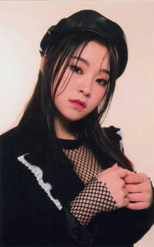 Photocard of Gahyun holding her hands together and staring at the camera