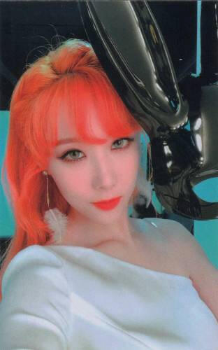 Photocard of Handong with bright orange hair staring at the camera
