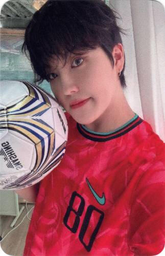 Photocard of Louis holding a soccer ball to his face