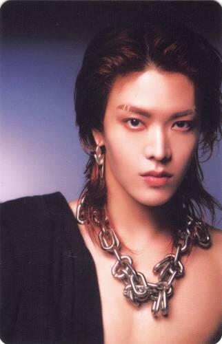 Photocard of Yuta with a thick chain necklace and his shirt draped over his shoulder