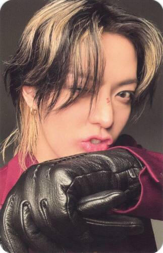 Photocard of Yuta holding a black gloved hand in front of his mouth