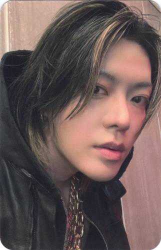 Photocard of Yuta wearing a black hooded jacket and looking to the side