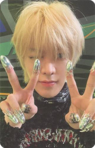 Photocard of Yuta making two peace signs with silver caps on his fingertips