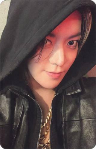 Photocard of Yuta wearing a black hooded jacket and smiling