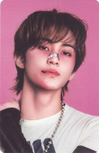 Photocard of Mark with bruises on his face holding his shoulder