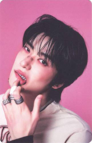 Photocard of Jaehyun pulling his bottom lip down with bruises on his face