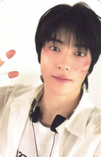 Photocard of Jaehyun making a peace sign with bandaids on his face