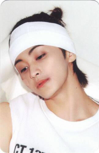 Photocard of Mark looking down to the side with a bandage wrapped around his head