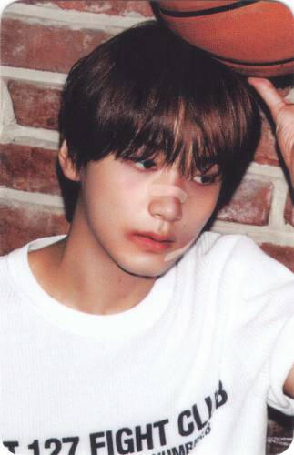 Photocard of Haechan with cuts on his face, holding a basketball on his head