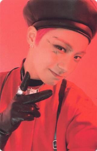Photocard of Hwanwoong holding up a peace sign, wearing a red shirt, black leather gloves, leather beret, and black suspenders