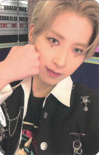 Photocard of Xion holding a fist to his cheek