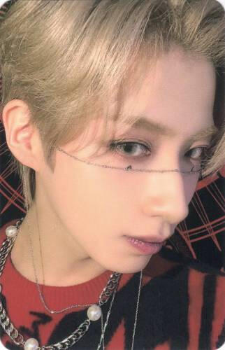 Photocard of Xion up close to the camera with a chain across his nose