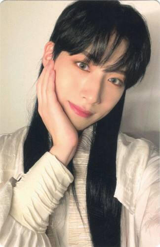 Photocard of Xion with long black hair cupping his face