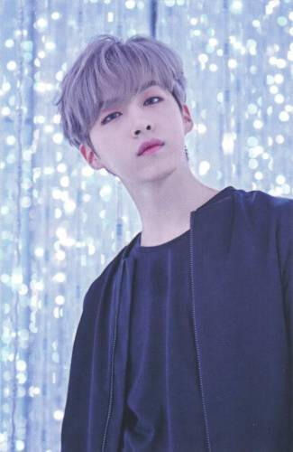 Photocard of Xion in a glittery silver room looking at the camera