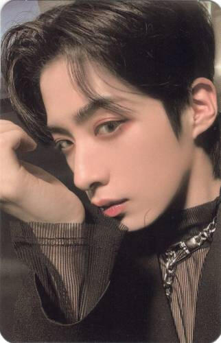 Photocard of Xion doing the same scent pose, holding his wrist by his face