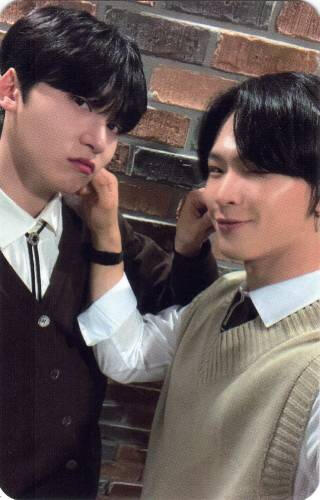 Photocard of Keonhee and Leedo pinching each other's cheeks, Leedo is smiling and Keonhee looks unamused