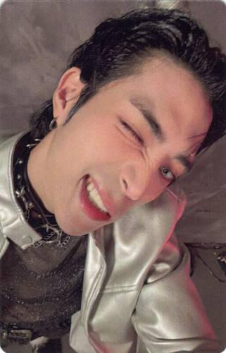 Photocard of Seunghyuk from ToThey looking up at the camera and baring his teeth in a grin