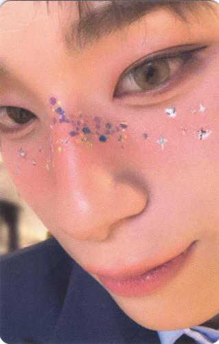 Photocard of Haru of Xlov closeup to the camera with glitter across his nose