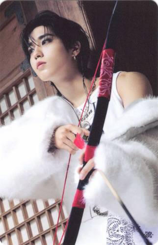Photocard of Han posing with a bow and arrow and looking off in the distance