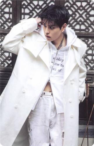 Photocard of Seungmin adjusting his coat collar and looking to the side
