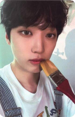 Photocard of Arthur holding a paint brush to his mouth
