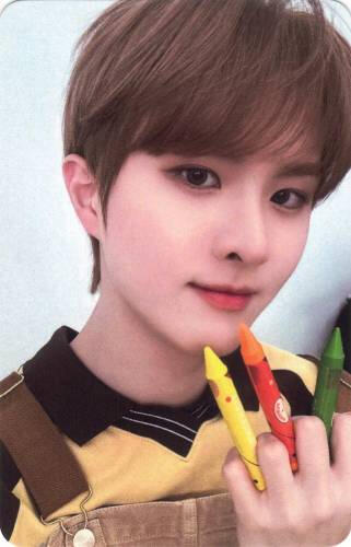 Photocard of Ivan holding three crayons in between his fingers like claws