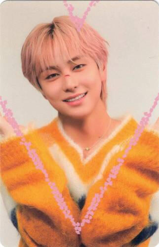 Photocard of Taki grinning in a yellow sweater with a pink heart drawn around him