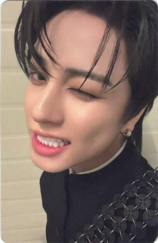 Photocard of Taki grinning while looking to the side