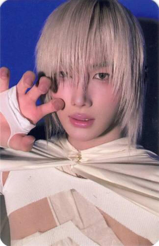 Photocard of Jo with silver hair making a clawed hand