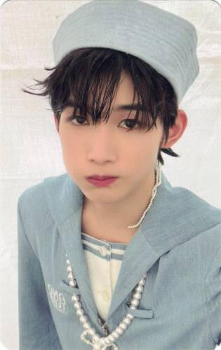 Photocard of Jo in a blue sailor outfit and puffing his cheeks