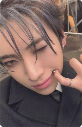 Photocard of Yuma pulling his lips to the side